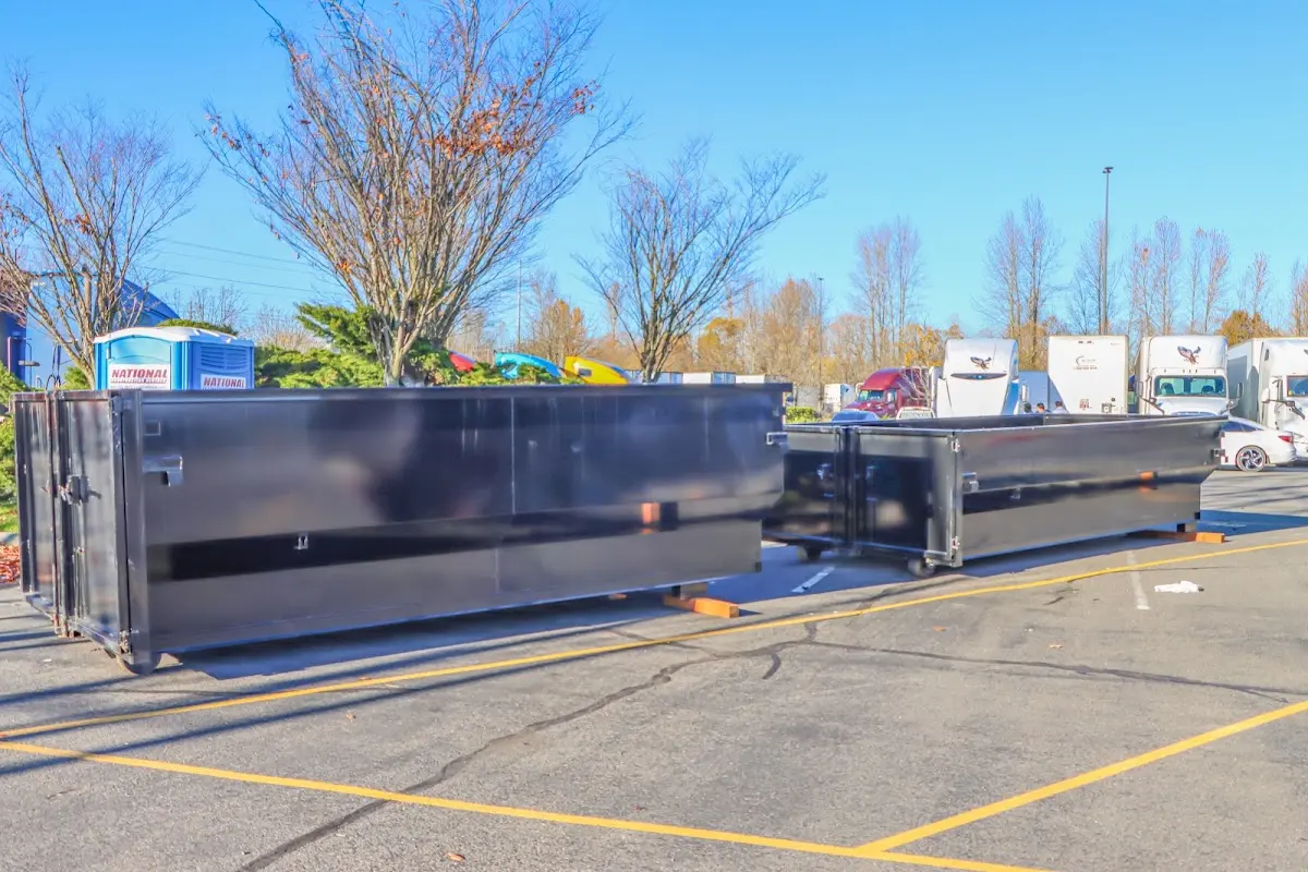 Professional dumpster rental service with roll-off container on residential driveway in Malvern